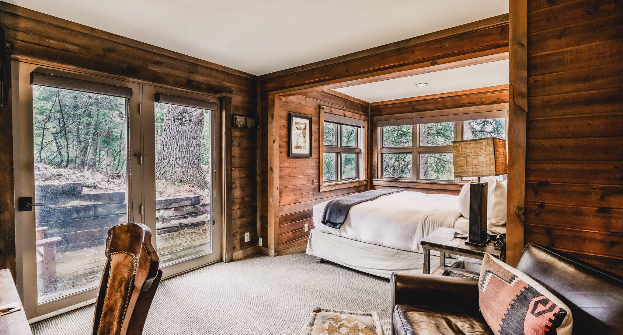 Standard Room with bed, chair, and windows with a mountain view.