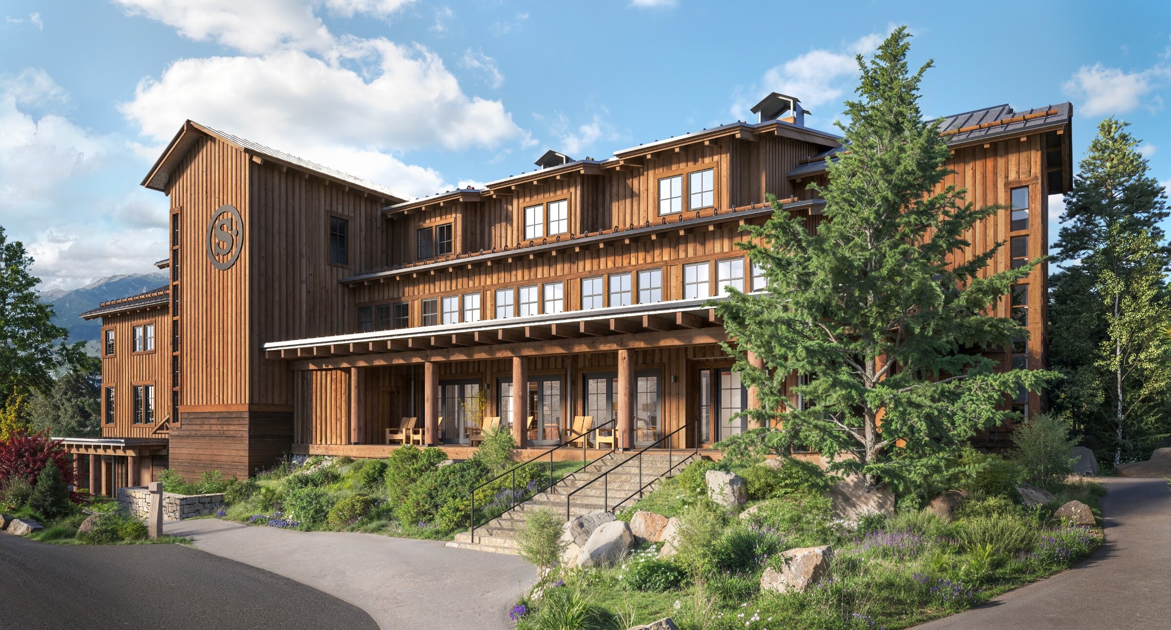 The front entrance of the Inn with blue sky and green landscaping.