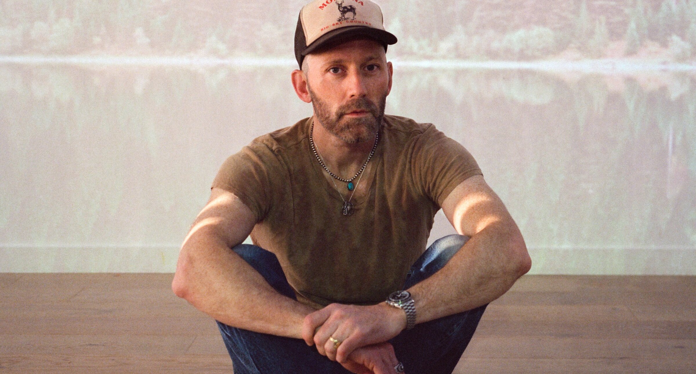 Mat Kearney sitting on the floor.