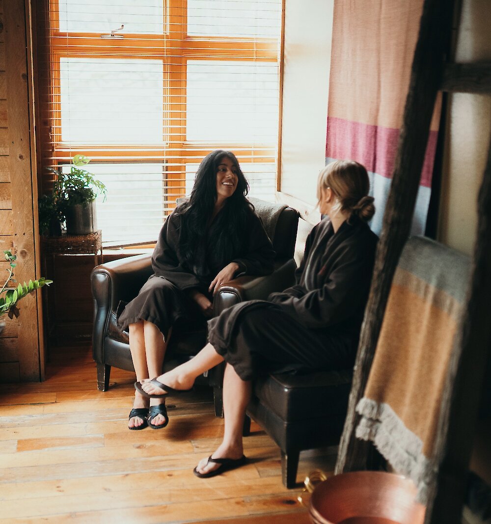 Two women visiting the Spa with light shining through the window.