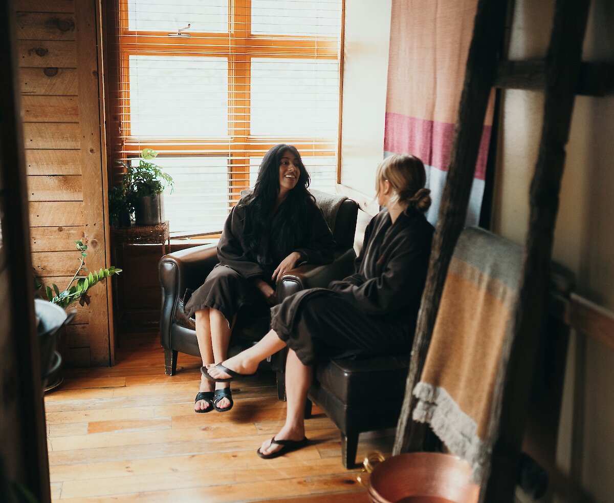 Two women visiting the Spa with light shining through the window.