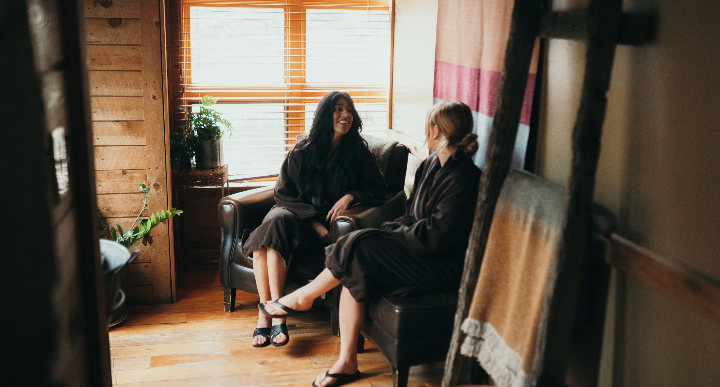 Two women visiting the Spa with light shining through the window.