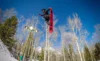 A snowboarder in the middle of a jump.