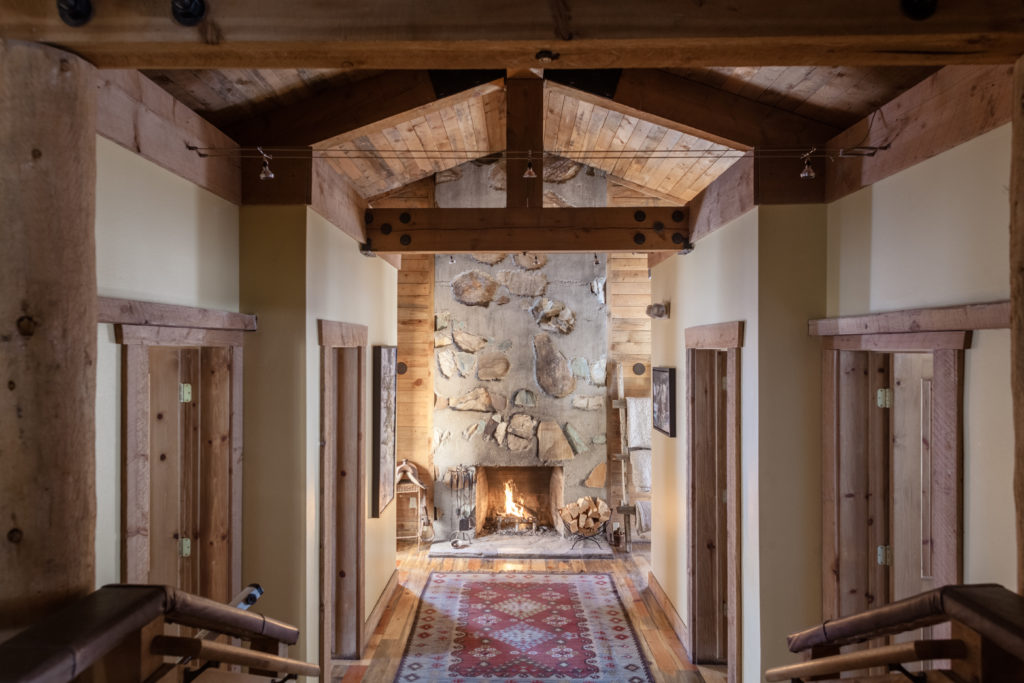 Inviting indoor space with high ceilings and a cozy fireplace.