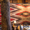 Close-up view of the historic tree in the middle of the Tree Room, with Native American art in the background.