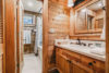 Beautiful cabin-style bathroom complete with vanity and tub/shower.