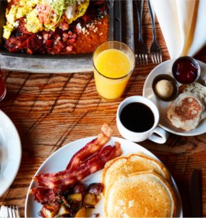 Pancakes, crispy bacon, eggs, and potatoes at the Foundry Grill breakfast.
