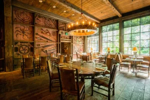 Rustic dining area in the Foundry Grill with large windows that allow for plenty of natural light.