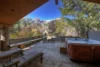 A hot tub sits on a wooden deck outside of spacious Cirque Crest House.