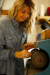 A woman making jewelry at the Sundance Art Studio.