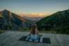 Morning yoga with a stunning view of the sunrising over the mountains.