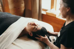 A woman lies on a comfortable bed during her relaxing massage.