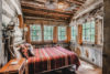 Fun nature-inspired bedroom filled with natural wood and beautiful views.