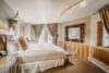 Graceful bedroom with doors leading to the patio at the Sunstone home vacation rental.