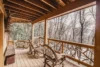 Beautiful wood deck with unique railings and chairs to sit and enjoy the view.