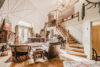 Cozy living room with a geometric domed ceiling and stairs leading up to the loft.