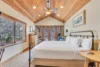 Stylish bedroom with a king-sized bed and double doors leading to a private deck.