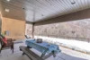 Covered backyard picnic area with a porch swing and a scenic outlook.