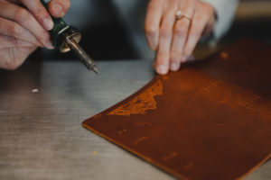The design process of creating a handmade leather-bound journal.