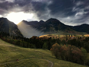 The autumn sun peeks through the clouds over the Sundance mountain bike trail.