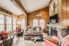 A rustic-inspired living room with a TV and fireplace for modern comfort.