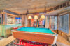 The Cascade Ridge home's family-friendly game room hosts a pool table, drink bar, and popcorn machine.
