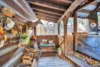 Cute covered patio and walkway with a porch swing off to one side.