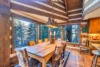 This cabin-style dining room has pretty views and space for 8 people at the table.