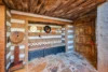 Lovely entryway with an adorable bench area and a massive wood door.