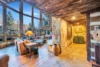 Vaulted ceilings and a combination of stone and wood accents adorn this beautiful entryway and living room.