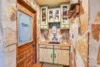 Charismatic vintage pantry with china displayed in the glass door cabinets.