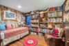 The reading room has a full wall bookcase along with comfy spots to curl up with a book.