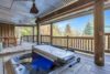 Fun outdoor deck with a hot tub and additional dining space.