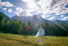 Prince Charming and Cinderella dancing in the meadow with a gorgeous mountain backdrop.