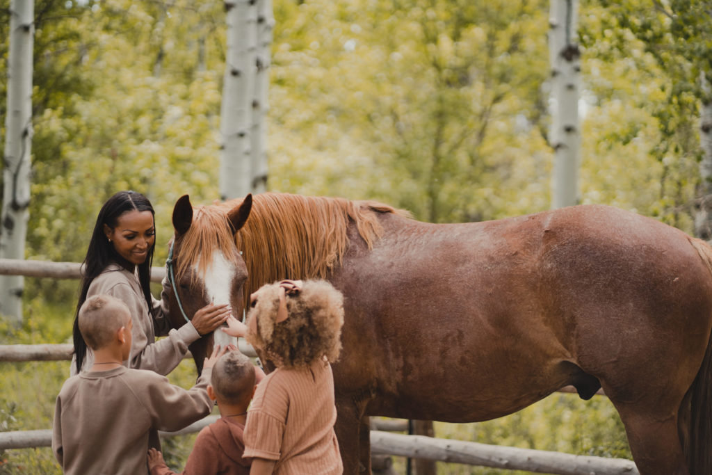 Mom and her three excited children meet one of Sundance's beatiful trail horses. 