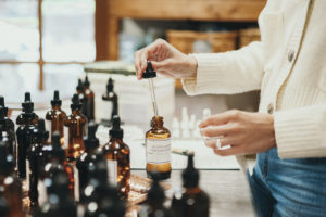 A woman in the process of making perfume.