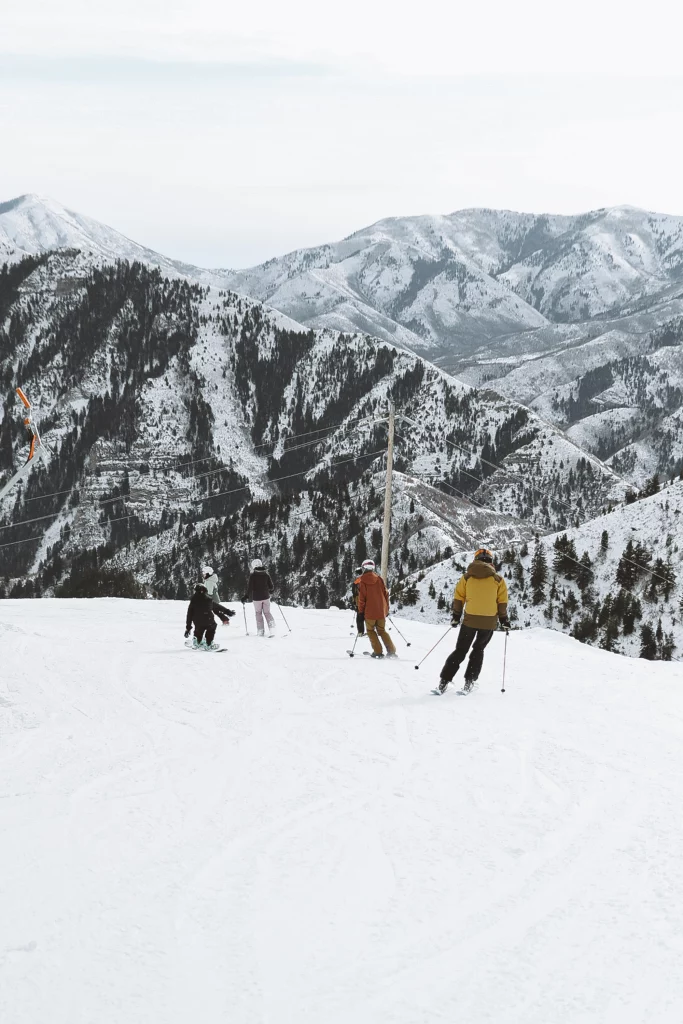 Skiers traveling down the mountain with beautiful scenery at Sundance Resort. 