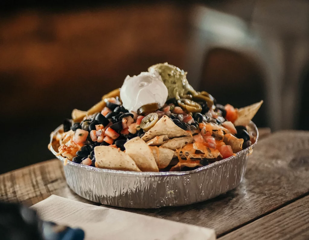 Delicious nachos with toppings piled high at Bearclaw Cabin.