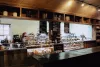 Morning view of the rustic deli with the pastries and various baked goods fully stocked.