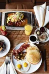 Pancakes, crispy bacon, eggs, and potatoes at the Foundry Grill breakfast.