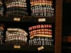 Shelves displaying neatly folded t-shirts in various colors with the word 