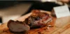 A delicious cut of meat displayed on a wood cutting board.